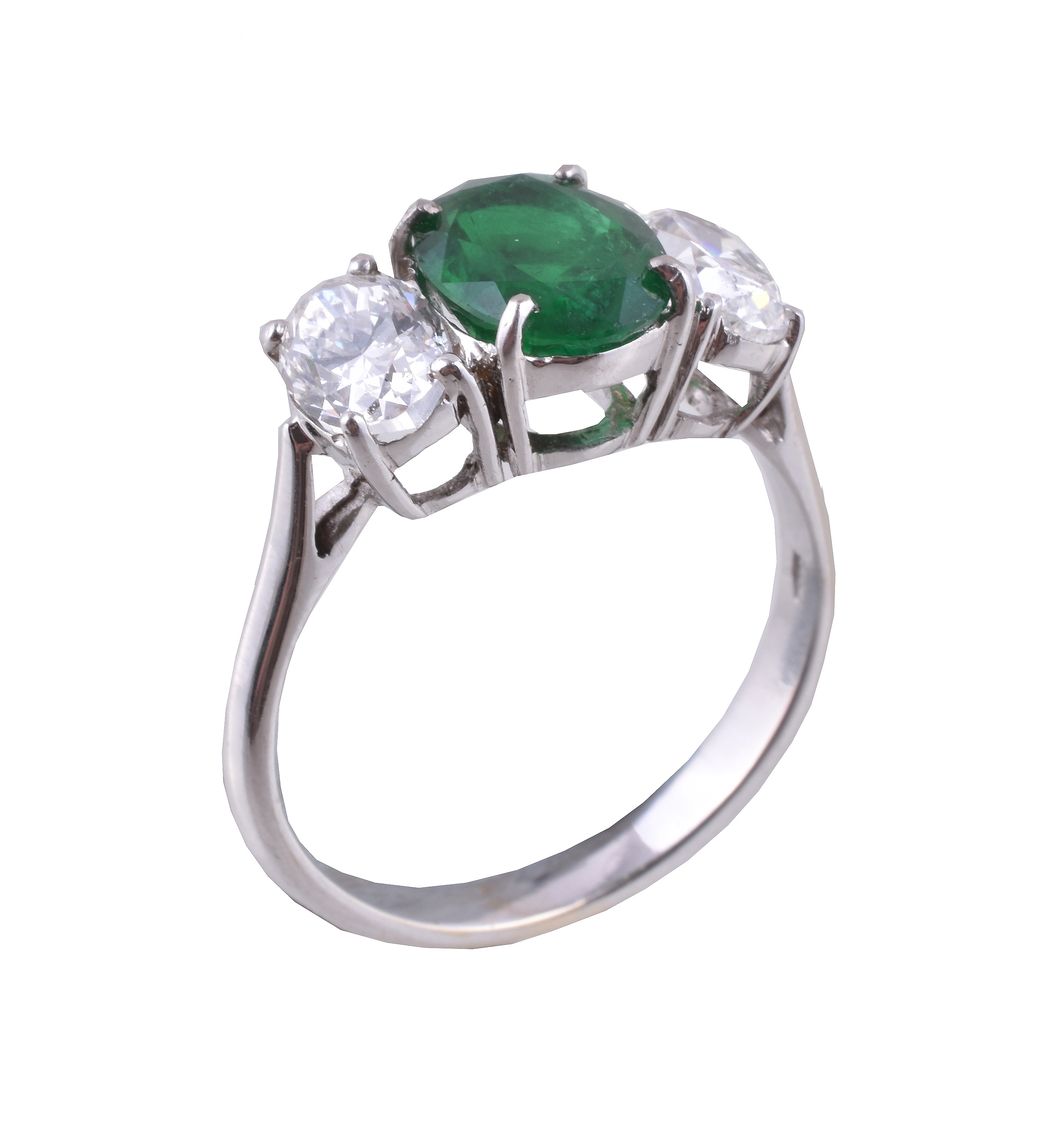 An emerald and diamond three stone ring 