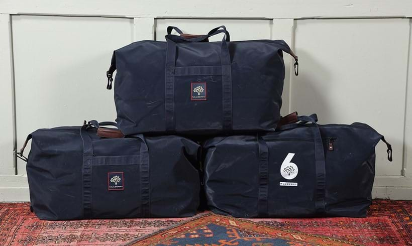 Inline Image - Lot 110: Three navy Mulberry Sporting Pursuits clipper bags. Sporting rubberised cotton with racing logo for the 6M European Championships that Roger & Mulberry raced in, each approximately 65 x 35cm | Est. £200-300 (+ fees)