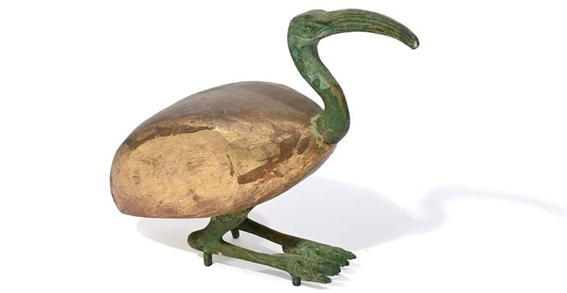 Inline Image - Lot 826: A Verdigris patinated metal mounted carved wood model of a hornbill or ibis, in Egyptian antique manner, 20th century | Est. £200-300 (+ fees)