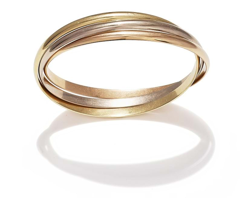 Inline Image - Cartier, a 'trinity' bangle composed of three interlocking tri coloured bangles | Sold for £5,040