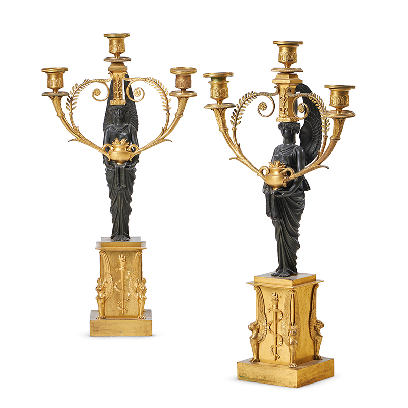 A pair of French empire gilt and patinated bronze three light candelabra