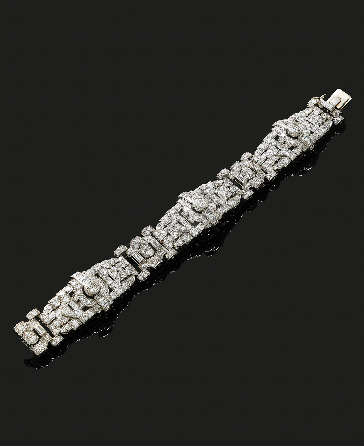 A mid 20th century diamond bracelet, the articulated geometric panels set with baguette, old European, brilliant cut and eight diamonds.jpg