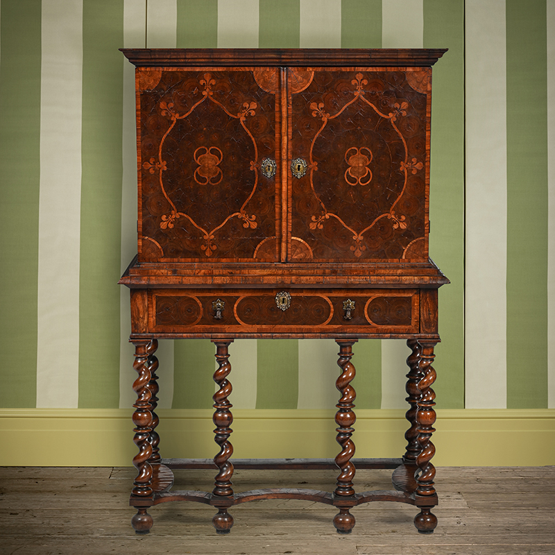 A William & Mary kingwood, tulipwood and oyster veneered cabinet on stand, circa 1690